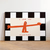 A black and white checkered wall art print featuring an orange silhouette of a figure with the text I love you this much