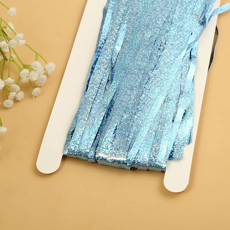 Blue metallic tinsel foil fringe curtain backdrop for parties displayed on a white card.
