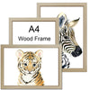 Two framed watercolor paintings featuring a tiger cub and a zebra head, displayed in wooden frames.