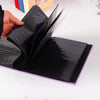 A black linen-cover photo album with 200 slip-in pockets is shown being held by a hand.