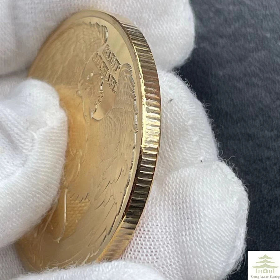 A gold souvenir coin is held in a white glove against a dark background.