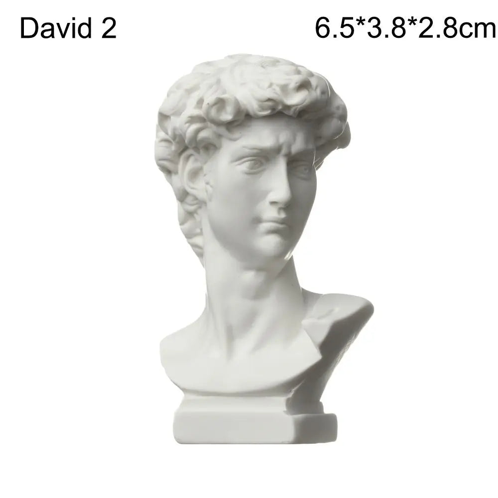 A white plaster bust miniature of a classical Greek figure, likely for art practice or home decor.