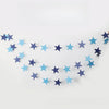 A crescent shape formed by a paper garland of metallic gold and silver stars.