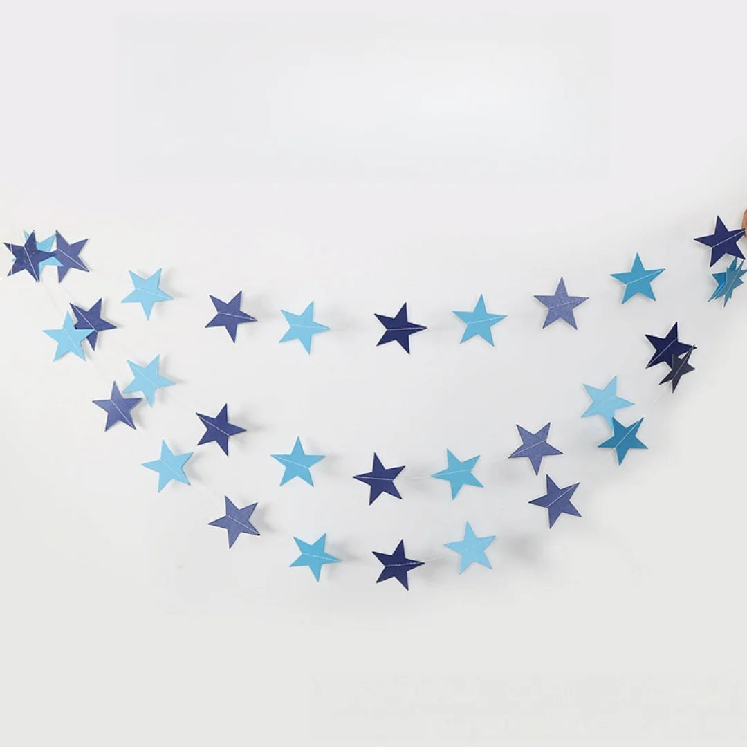 A crescent shape formed by a paper garland of metallic gold and silver stars.