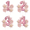 Assorted pink and gold foil balloons shaped like the number one, five, and four with bows