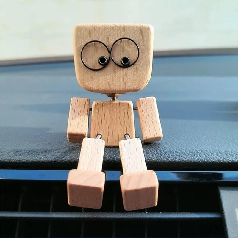 A small wooden figurine of a man with an infinity symbol on his head, standing upright.