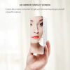 A hand holds an HD mirror display screen showing a woman's face.