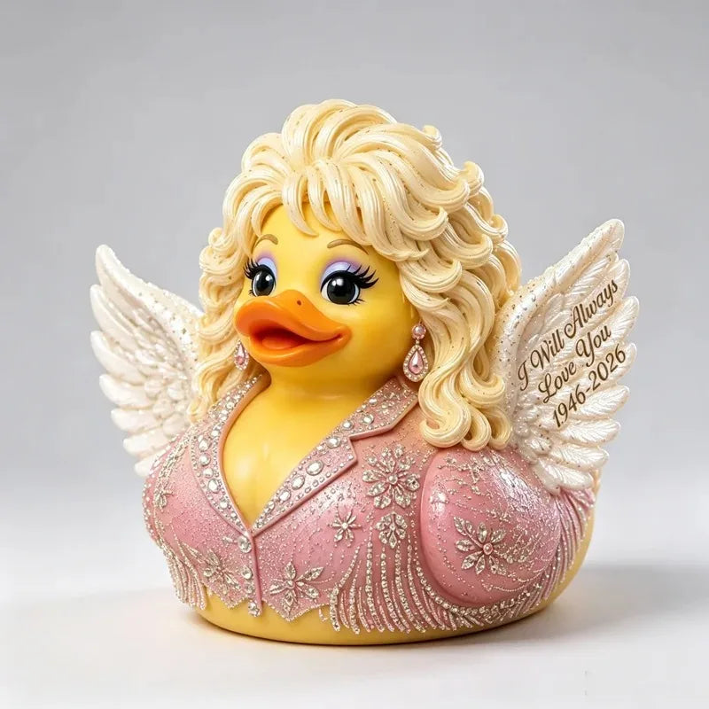 A yellow resin figurine of a duck with blonde hair and pink embroidered clothing, featuring delicate white wings.