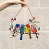 Colorful acrylic hummingbird suncatcher with painted birds and leaves hanging from a twine string