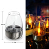 Klares Glas-Kerzenhalter mit Metallbasis und flackernder Flamme, für Outdoor-Dekoration.