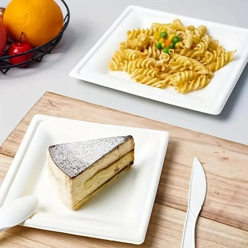 A white square paper plate holds a slice of layered cake on a wooden surface.