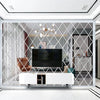 A modern living room featuring a diamond-patterned mirror wall and contemporary furniture.