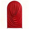 A vibrant red draped fabric arch cover used for weddings and events.