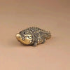 A detailed brass alligator sculpture used as desk decor.