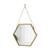 A gold-framed hexagon decorative wall mirror hanging by a chain.