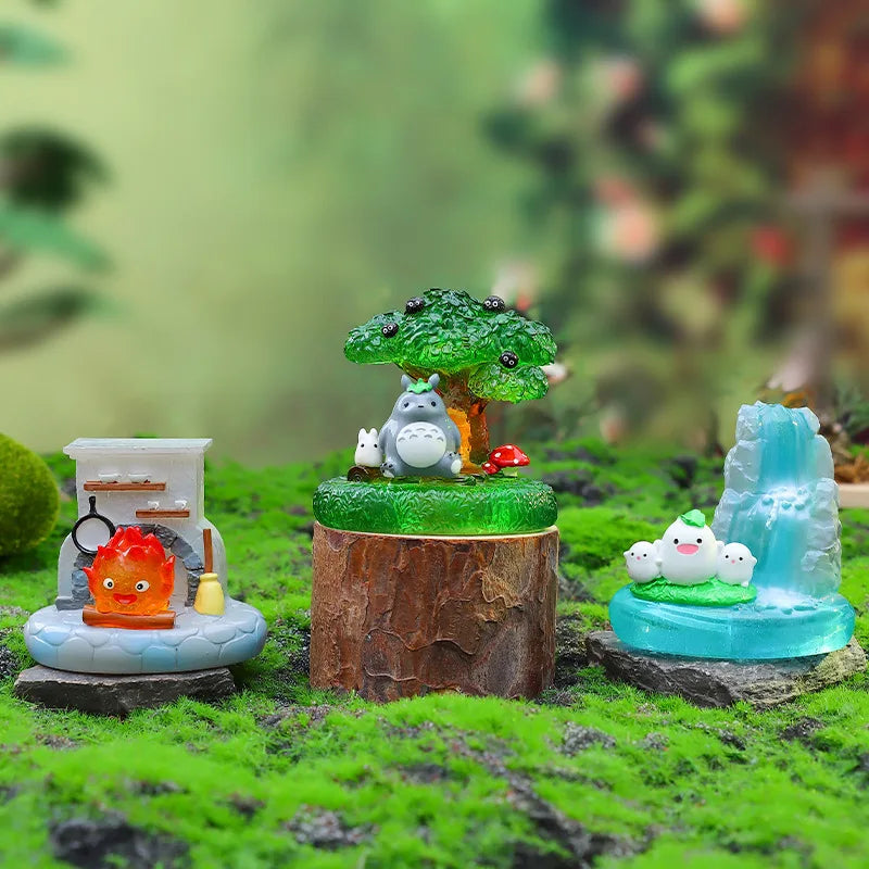 A miniature fairy tale scene featuring a tree, a gray animal, and small figures on mossy terrain.