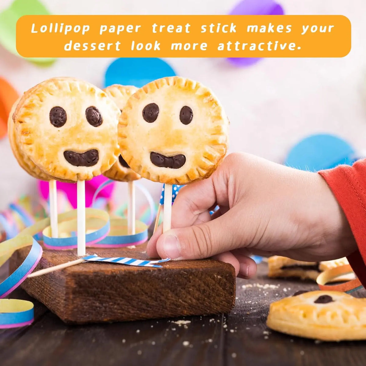 A hand is holding a white paper lollipop stick with a food item on it, demonstrating how the stick makes dessert look attract