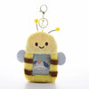 A yellow fluffy keychain featuring a cute character design on the front.