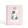 A pink photo album cover titled Pieces of Moment for instax mini cameras