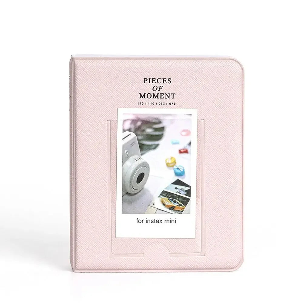 A pink photo album cover titled Pieces of Moment for instax mini cameras