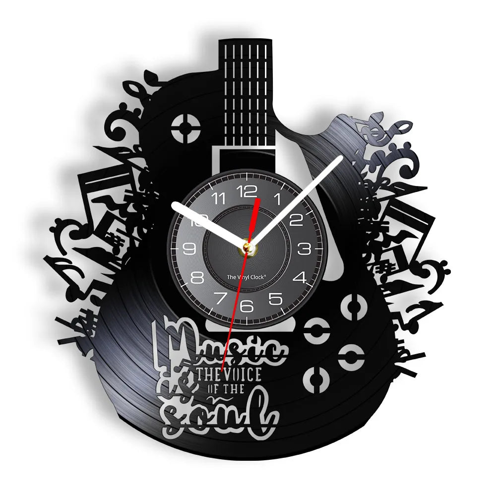 A black wall clock shaped like a vinyl record featuring a guitar design and clock face.