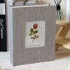 A gray linen cover photo album with a square window displaying a red rose and the text Flower language.