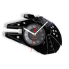 A black wall clock shaped like the Millennium Falcon, featuring a circular face and hands.