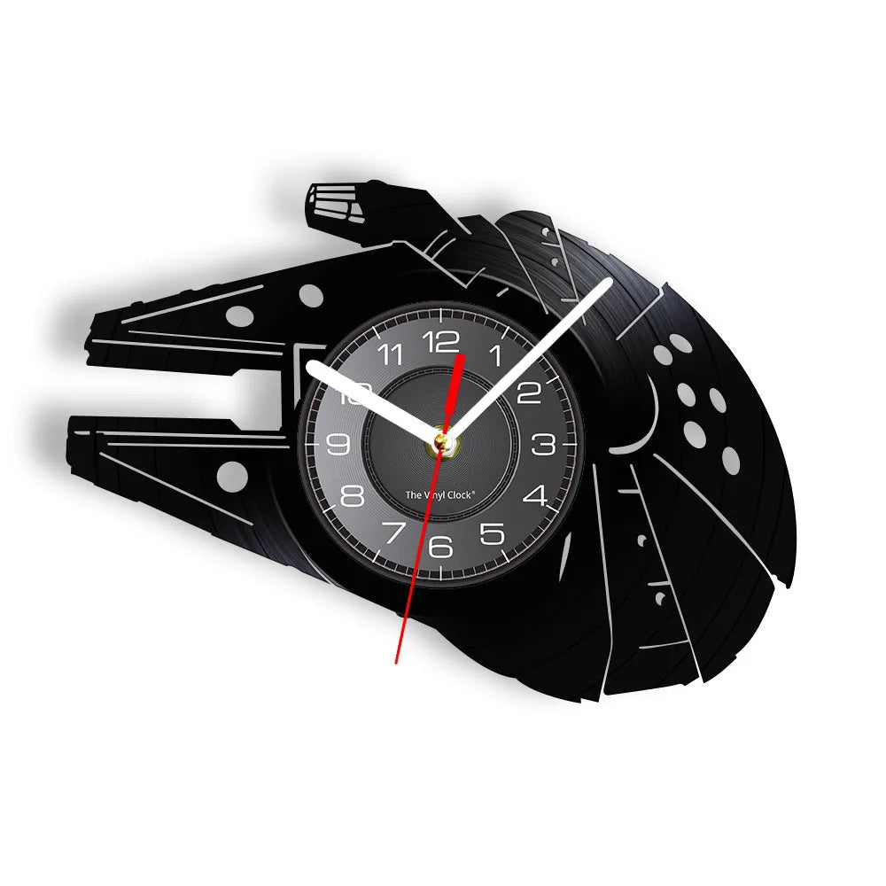 A black wall clock shaped like the Millennium Falcon, featuring a circular face and hands.