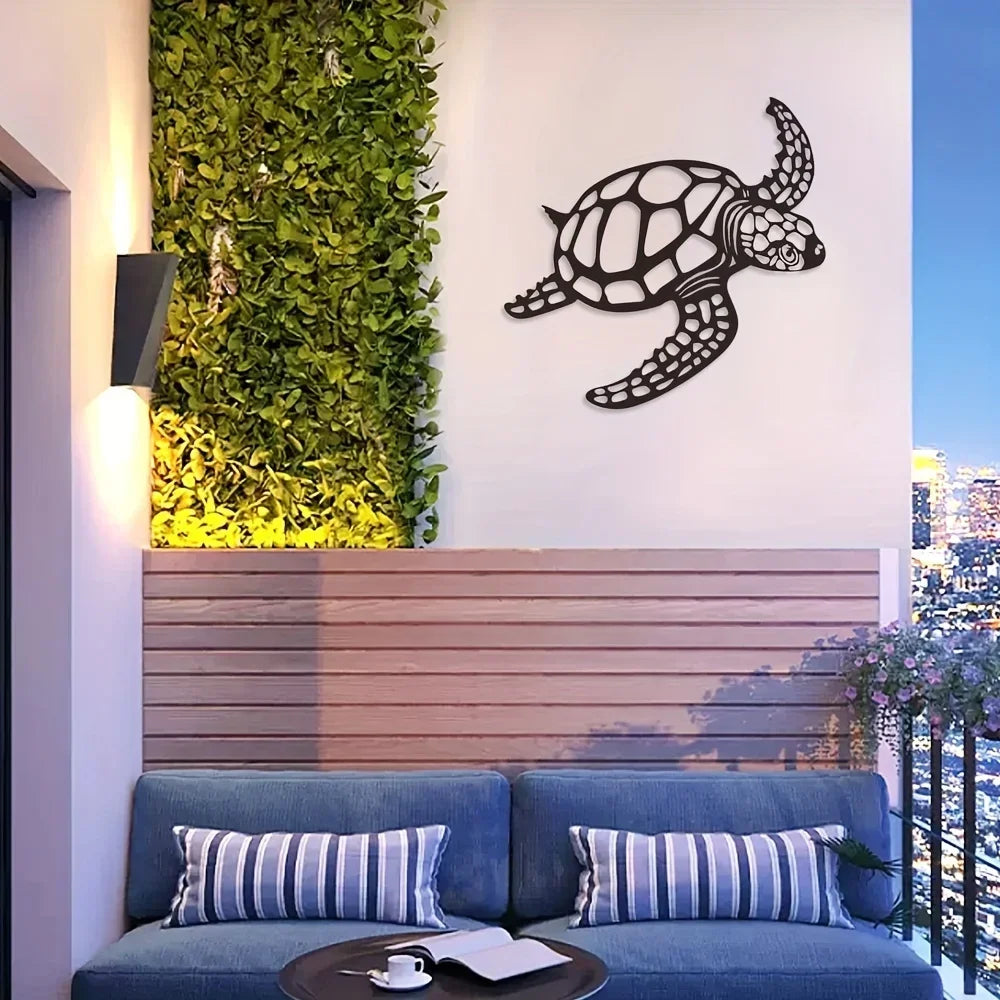 A dark metal sea turtle wall art piece is displayed on a white wall above a wooden panel and a blue sofa.