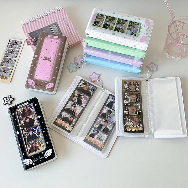 A collection of photo booth albums and photo strips in various colors and designs are displayed on a white surface.