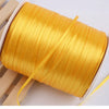 A roll of bright gold yellow satin ribbon for crafts and gift wrapping