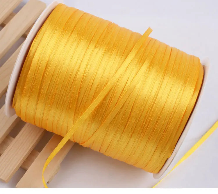 A roll of bright gold yellow satin ribbon for crafts and gift wrapping