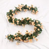 A green silk rose vine garland used for wedding and home decor