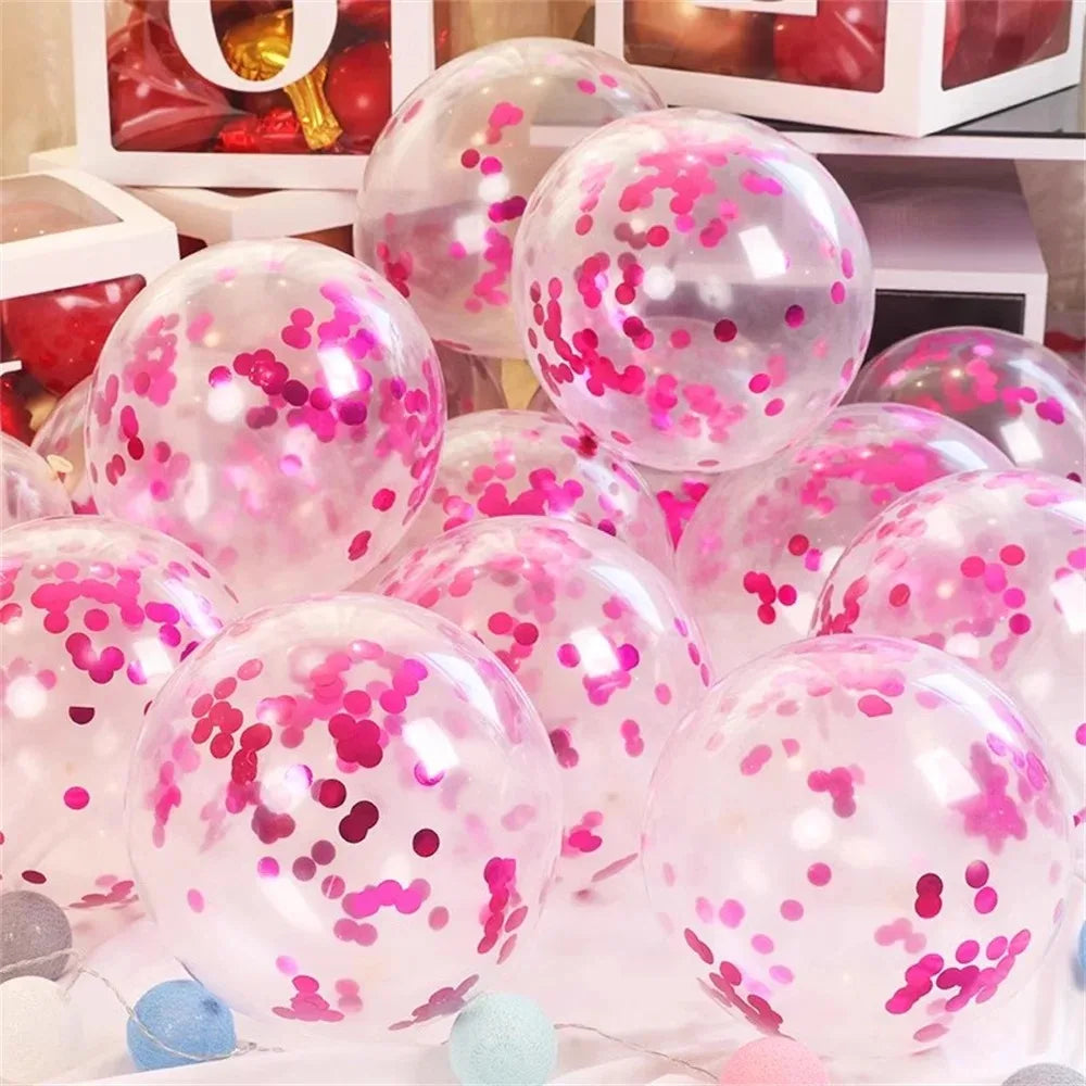 A collection of pink and purple metallic confetti balloons are displayed on a white surface.