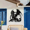 A black metal dragon wall sculpture mounted on a white exterior wall next to a blue wooden door.