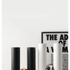 A collection of black and white ceramic U-shaped tabletop vases displayed on a white surface.