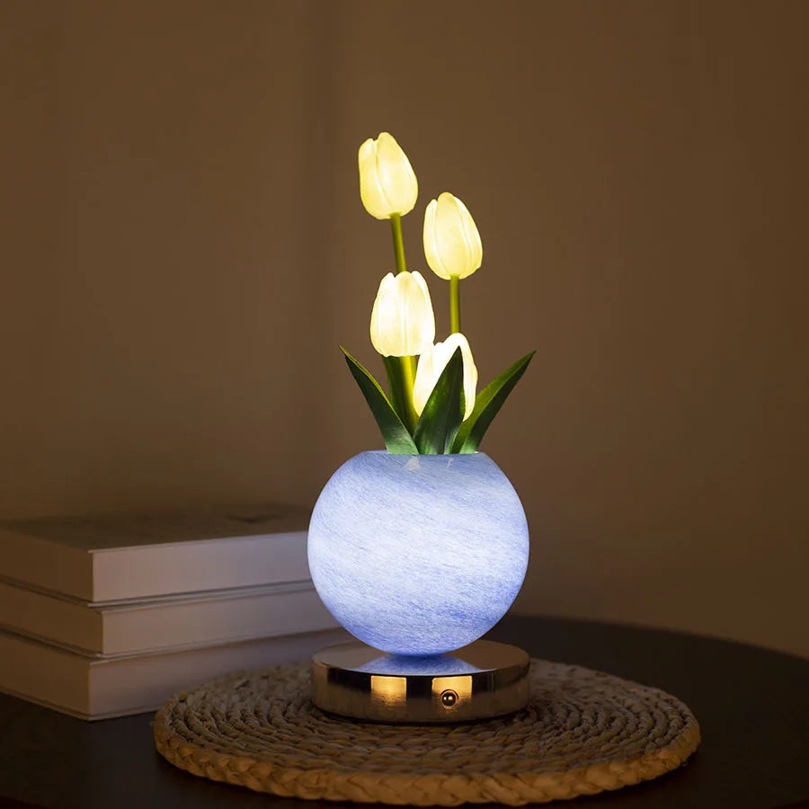 A white tulip LED night light with touch dimming is displayed on a woven mat.