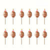 A set of ten personalized baby photo cupcake toppers featuring baby faces on pink and yellow conical shapes.