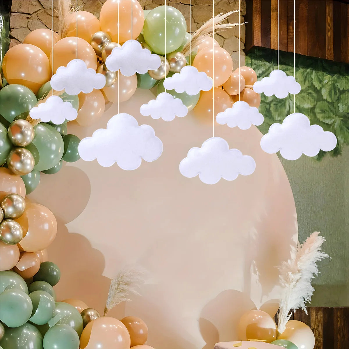 A cluster of pastel colored balloons and white cloud felt decorations arranged in a circular display.