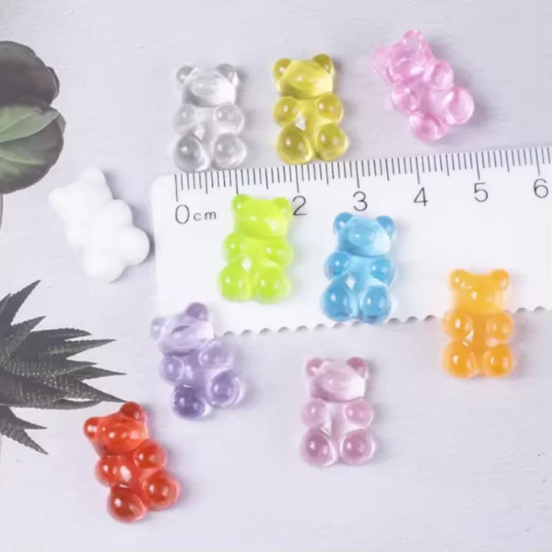 A set of ten bear-shaped magnetic chalkboard and message stickers in various colors arranged next to a ruler.