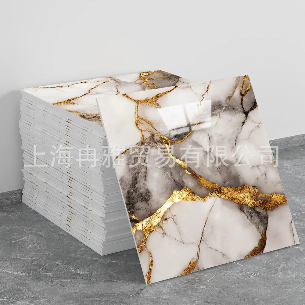 Stack of faux marble 3D self-adhesive wall tiles featuring white and gray marble patterns with gold veining