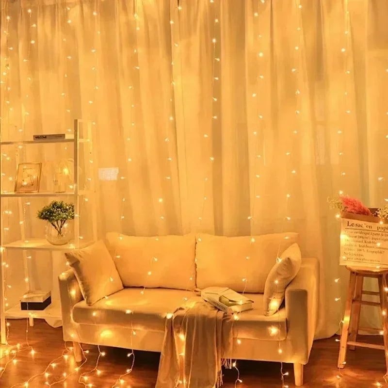 A cozy interior decorated with yellow fairy curtain string lights illuminating a sofa and display shelves.