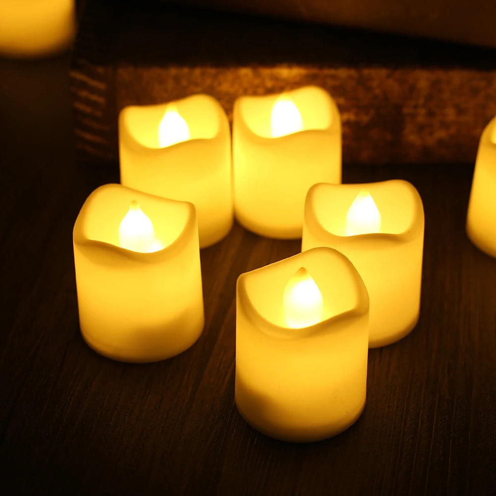 A close-up of several glowing yellow LED tealight candles arranged on a dark surface.