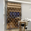 A rectangular diamond-patterned mirror with a silver frame reflecting an interior room.