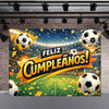 A vibrant soccer field backdrop with a goal, celebrating a birthday with the text Feliz Cumpleaños in gold and yellow confett