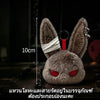 A dark brown bunny plush toy with red eyes and silver hardware, displayed against a dark background.