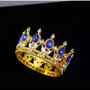 Gold crystal rhinestone crown cake topper with blue gemstones and white accents