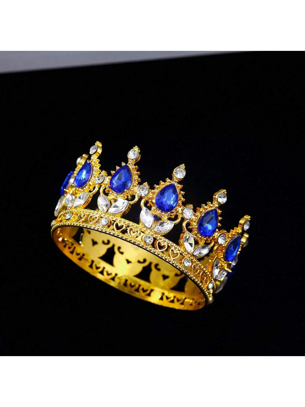 Gold crystal rhinestone crown cake topper with blue gemstones and white accents