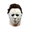 A white latex horror mask resembling Michael Myers with dark, messy hair.