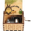 A hand-cranked wooden music box featuring a Totoro design on the lid.